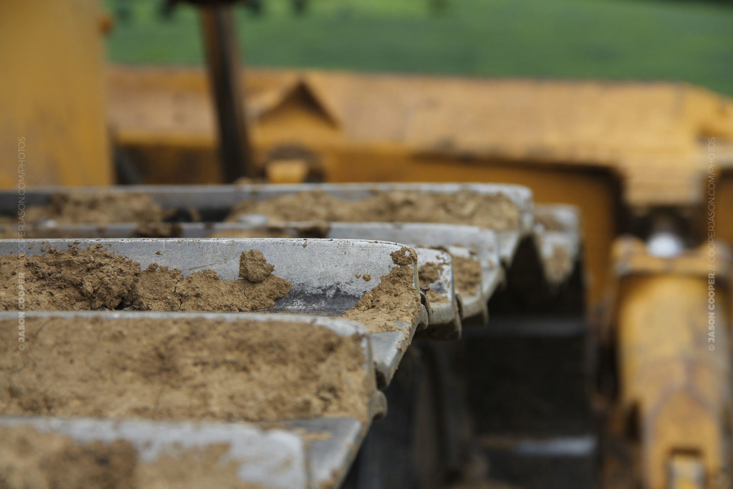 closeup photo of dirty bulldozer tracks