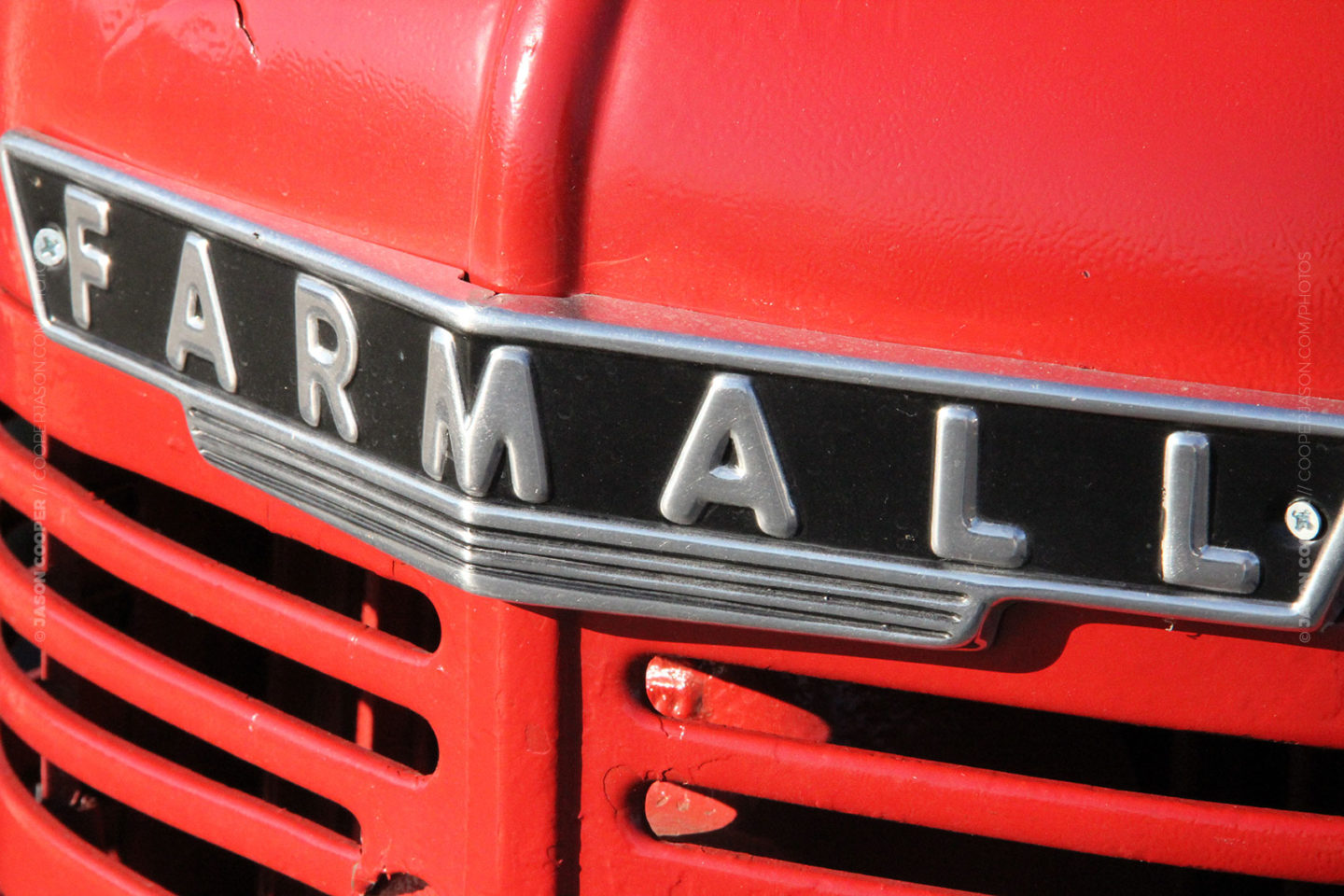 photo of the grill of an old red McCormick Farmall tractore