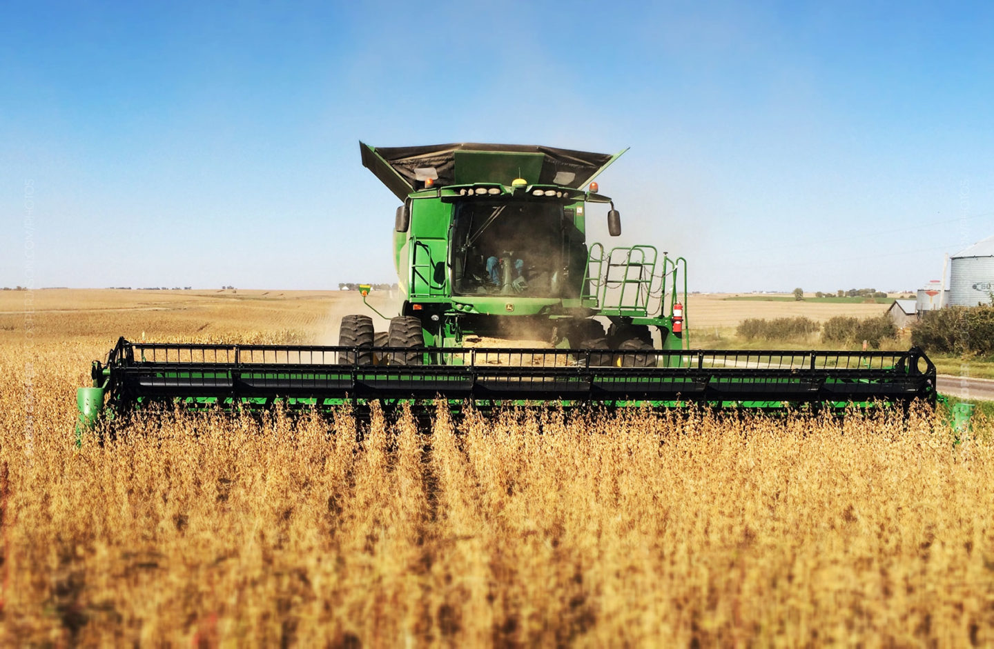 John Deere combine harvesting soy beans in an Iowa field